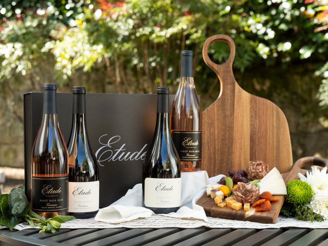 Etude wine bottles with charcuterie board, featuring Pinot Noir Rosé and Pinot Blanc varieties.