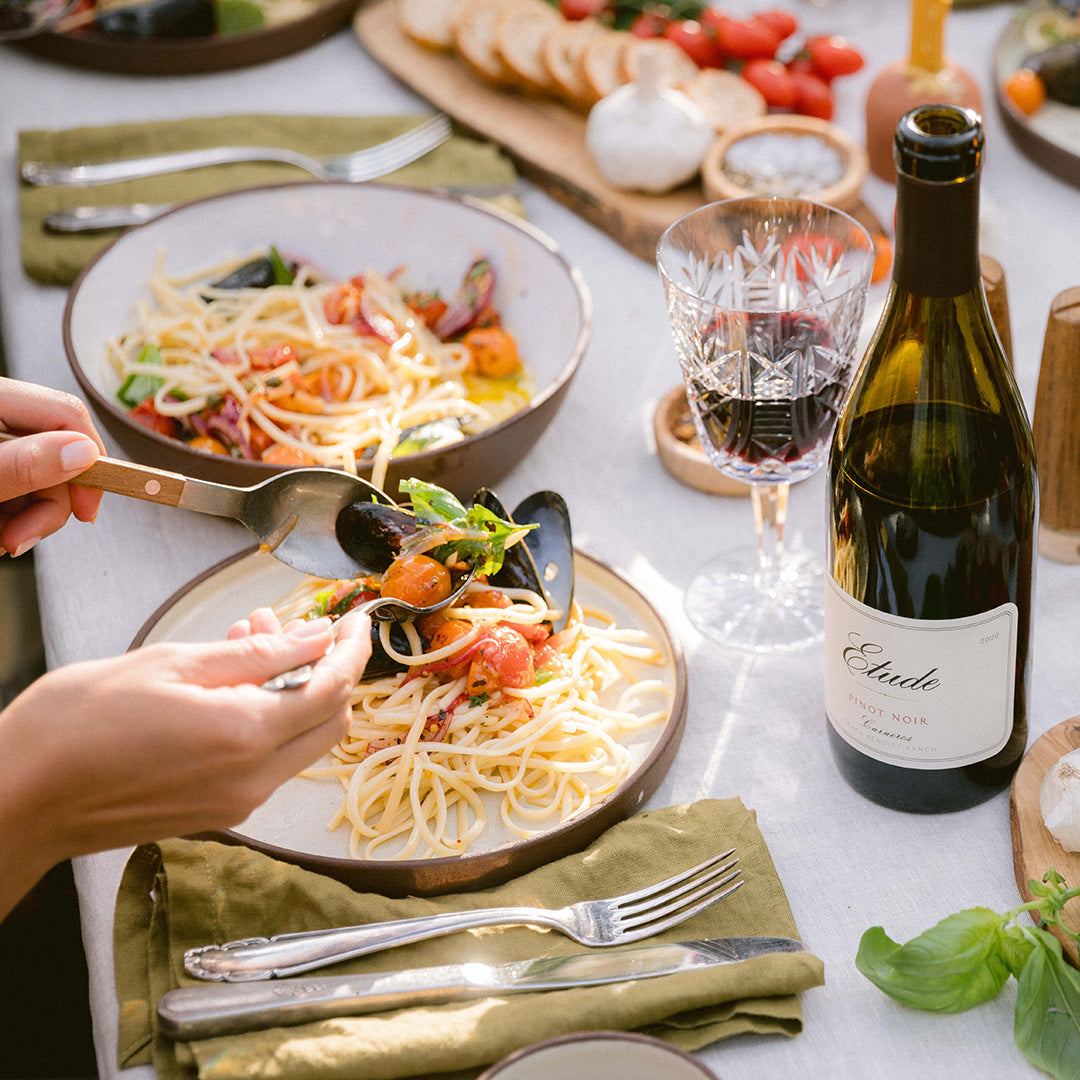 Pasta with mussels and cherry tomatoes, served with a glass of Etude Pinot Noir.
