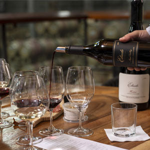 Wine tasting: someone pouring Etude Napa Valley Cabernet into a glass