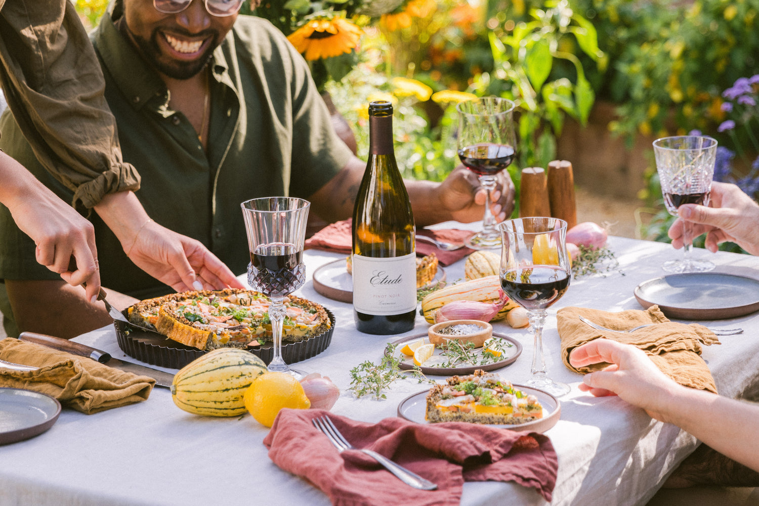 Friends enjoying a fall harvest meal with Etude Pinot Noir wine.