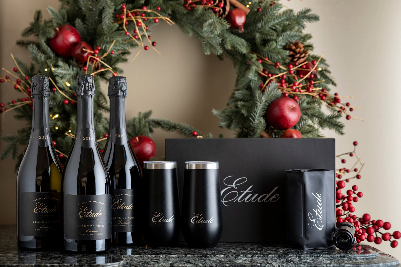 Three bottles of Etude Blanc de Noirs sparkling wine in a gift set with black insulated wine tumblers.