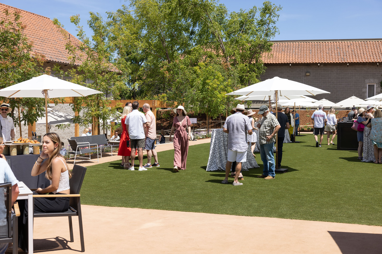 Guests enjoying wine tasting at an outdoor event at Etude Wines.